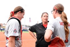 Coach talks between innings with her pitcher, Shelby McCombs & catcher